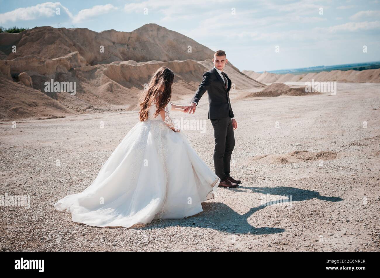 Newlyweds walk in a sandy quarry Stock Photo Alamy