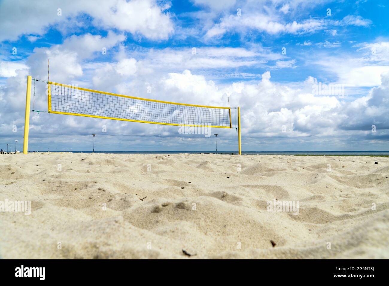Volleyball net on the seaside beach with white clouds on blue sky Stock Photo