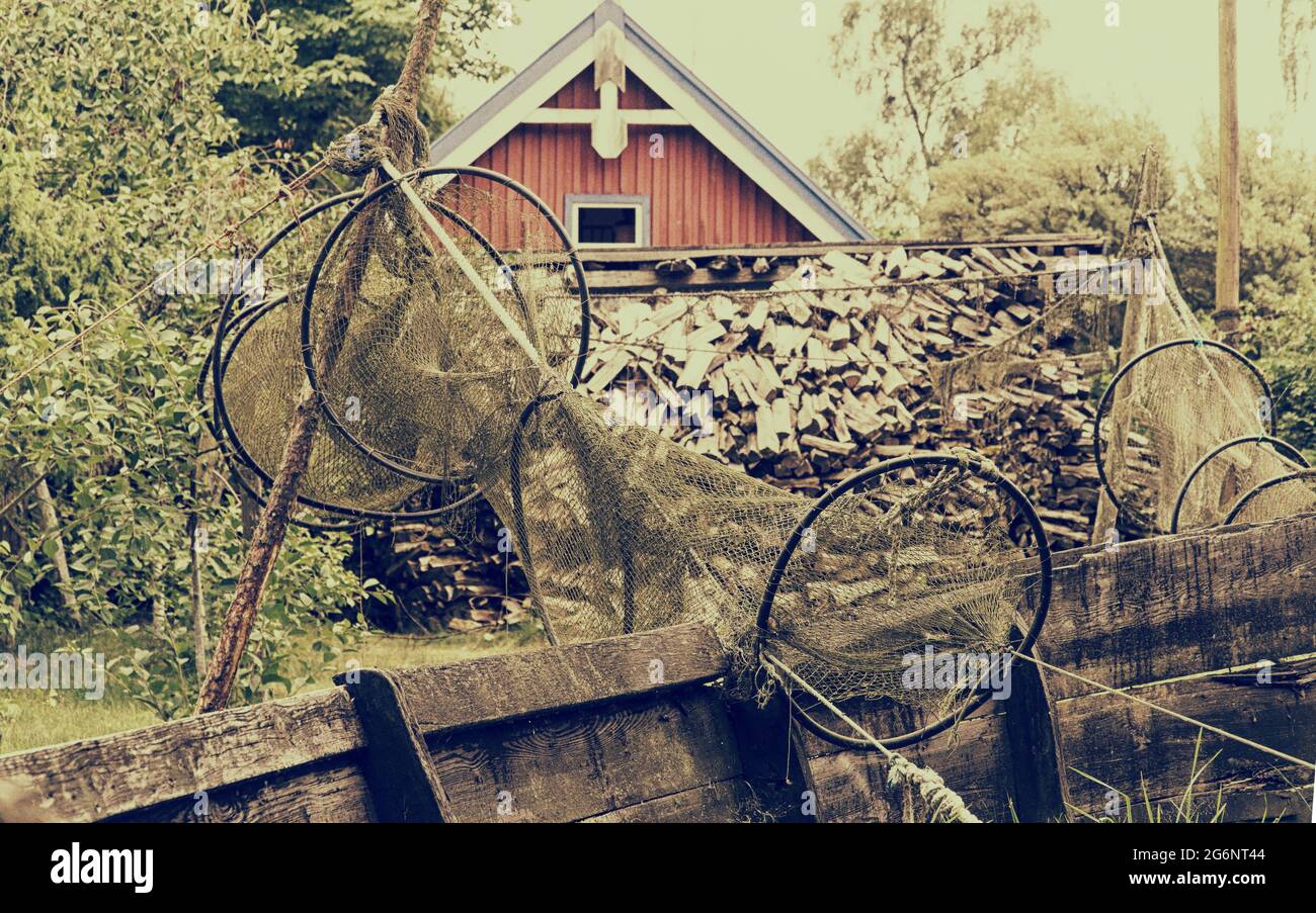 Old wooden fishing boat, drying up fishing net. Vintage filter effect Stock Photo