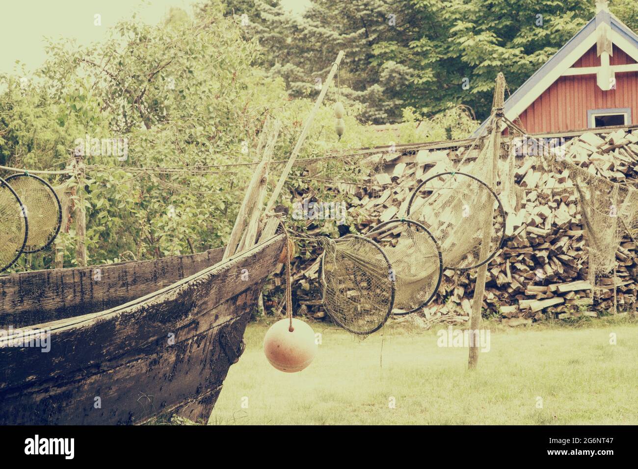 Old wooden fishing boat, drying up fishing net. Vintage filter effect Stock Photo