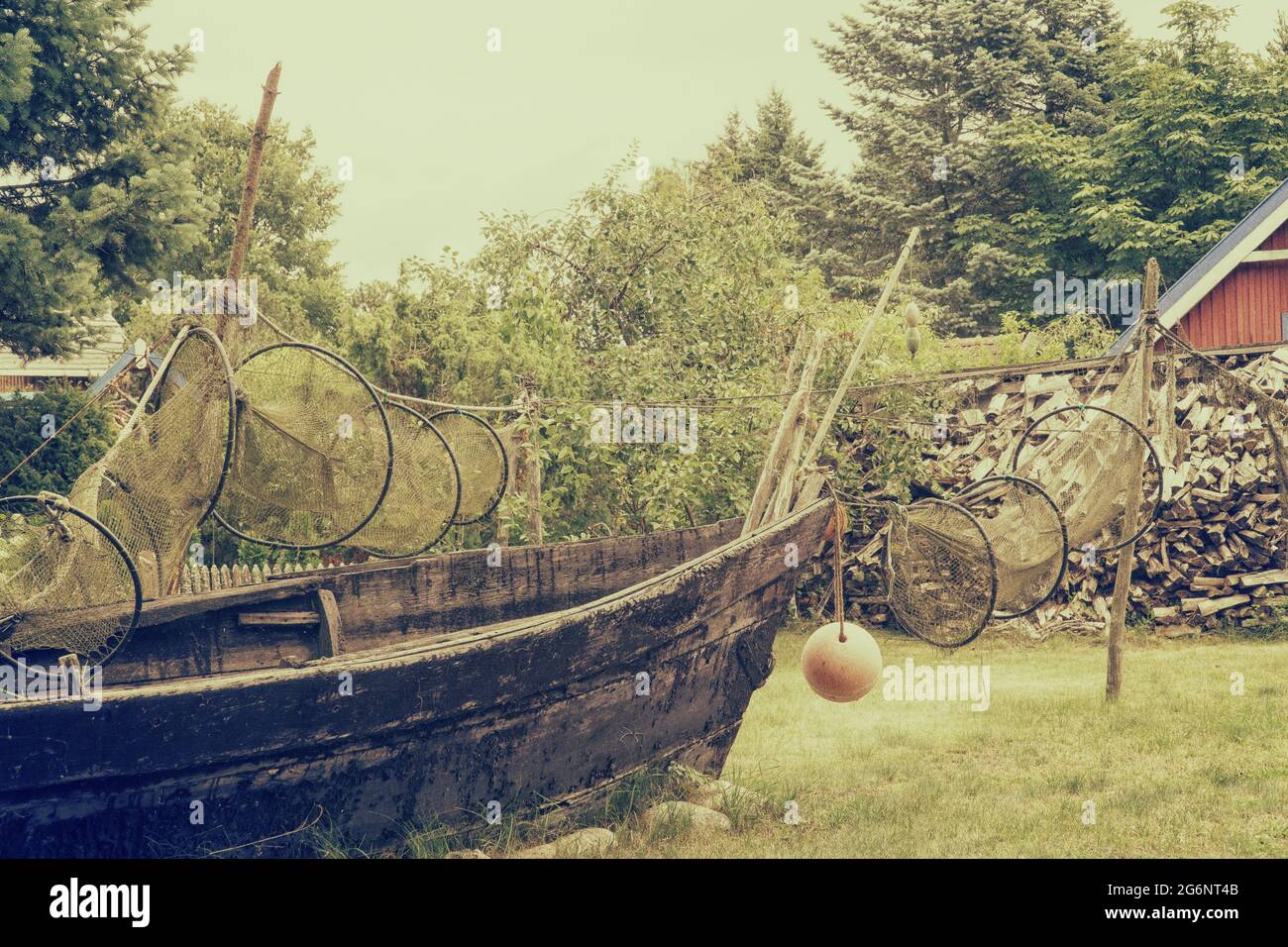 Old wooden fishing boat with drying up fishing nets. Vintage filter effect Stock Photo