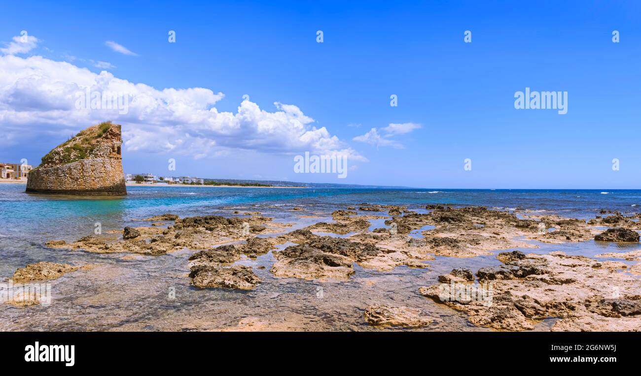 Salento coast: Torre Pali in Apulia, Italia.The ruined sixteenth century watchtower of Torre Pali, surrounded by crystal clear water. Stock Photo