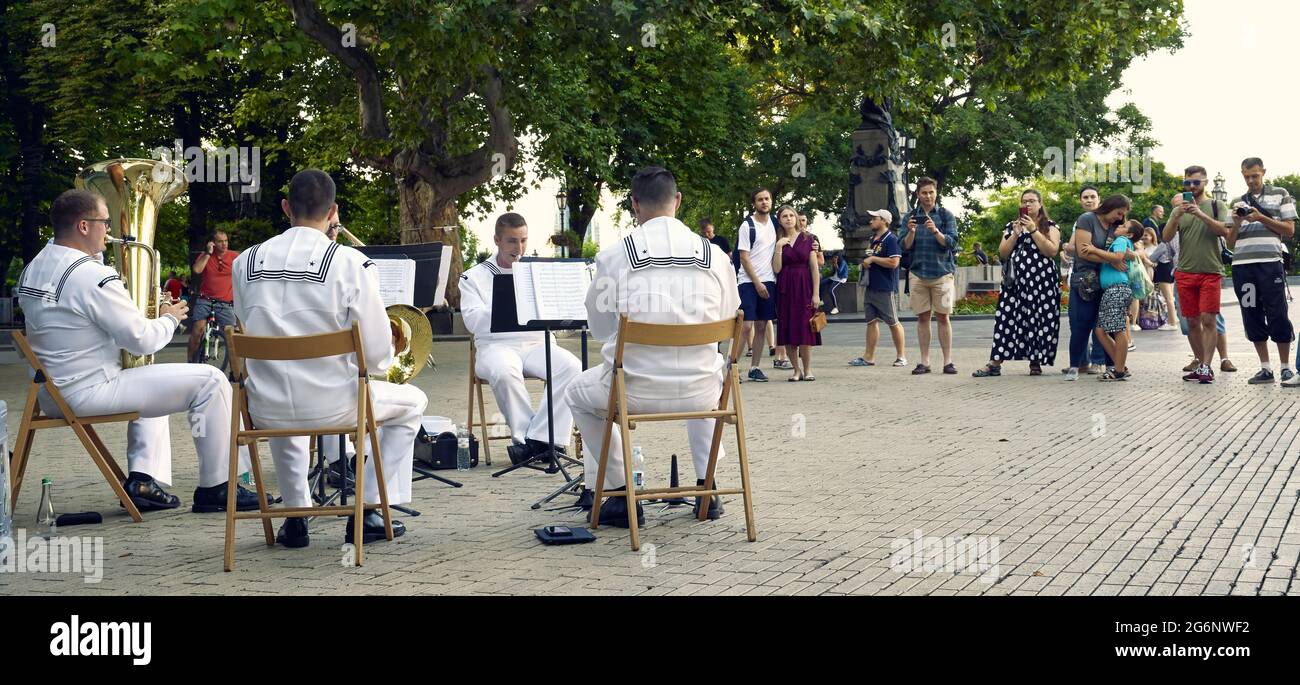 The US Navy brass quintet of the US 6-th Fleet Orchestra plays on the Dumskaya square in Odessa, Ukraine. Summer time, natural light. Stock Photo