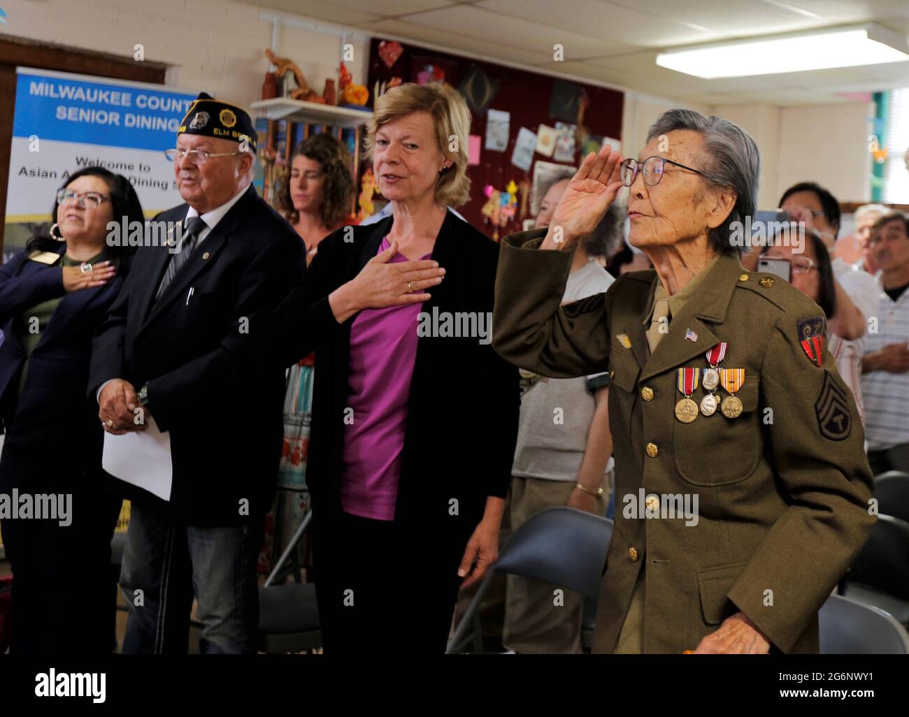 July 7, 2021, Milwaukee, Wisconsin, U.S: DR. DAVID TOY (right to left), U.S. SENATOR TAMMY BALDWIN, ALEX KOLANDER, Commander of American Legion Post 449, and regional representative to Baldwin, VANESSA L. LLANAS stand as they recited the Pledge of Allegiance during opening ceremony. The Organization of Chinese Americans-Wisconsin Chapter and the Chinese Golden Age Club of Milwaukee honored.DR. DAVID TOY, 97, Wednesday July 7, 2021, as he receives the Chinese-American World War II Veteran Service Medal at the Chinese Community Baptist Church in Milwaukee. DR. DAVID TOY was not a U.S. citizen w Stock Photo