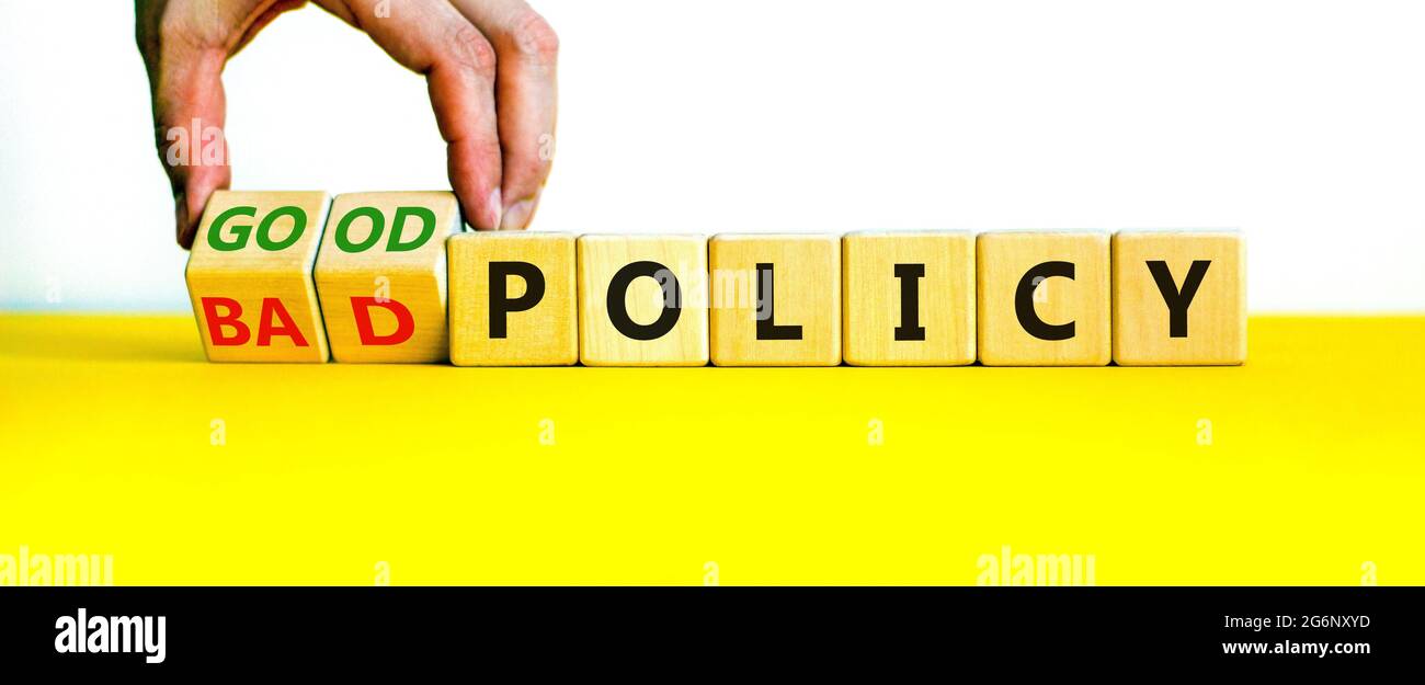 Good or bad policy symbol. Businessman turns wooden cubes and changes