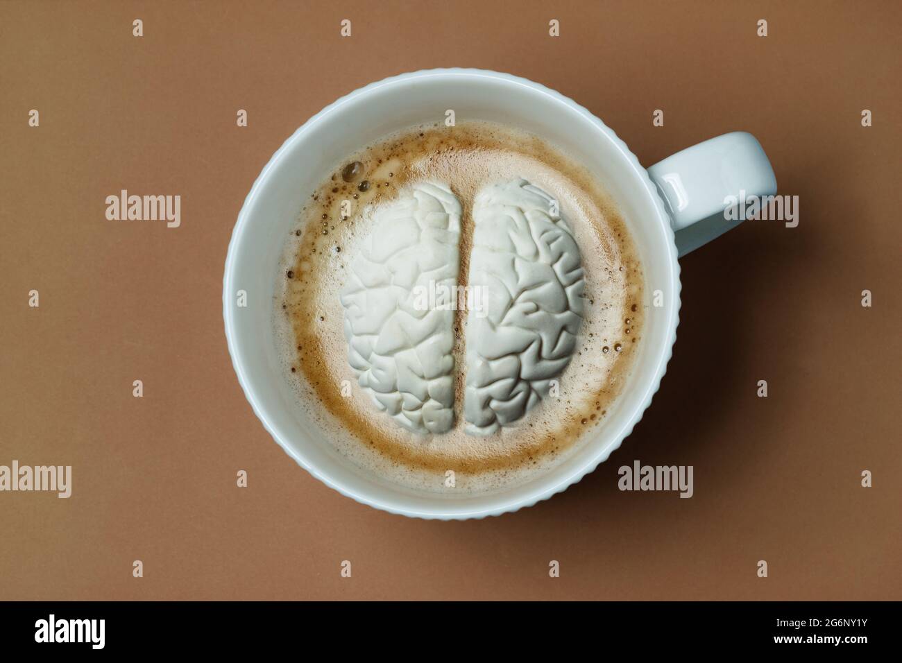 Brain submerged like marshmallow in coffee cup Stock Photo