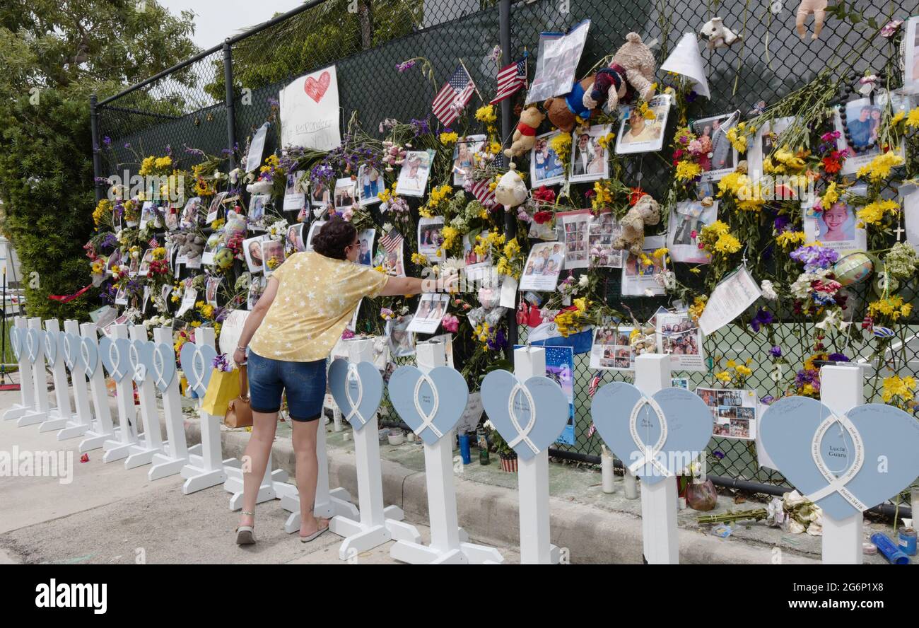 Surfside, United States. 07th July, 2021. People place flowers and say a prayer for the missing victims at the memorial outside St. Joseph Catholic Church near the collapsed Champlain Towers South condo in Surfside, Florida on Wednesday, July 7, 2021. News reports said that 46 people have died since the collapse over week ago. Photo By Gary I Rothstein/UPI Credit: UPI/Alamy Live News Stock Photo