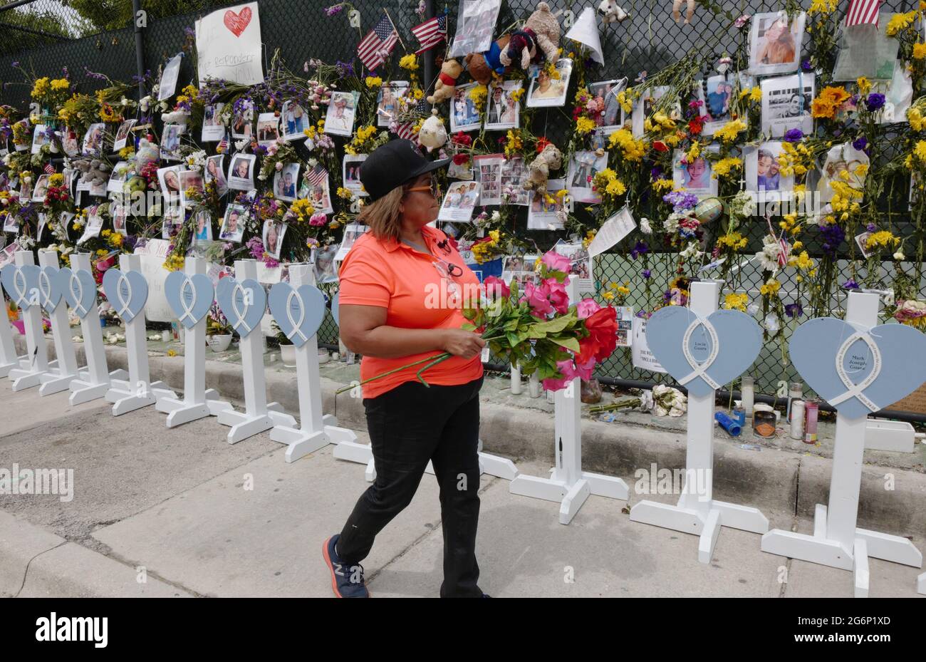 Surfside, United States. 07th July, 2021. Lucia Gutierrez places flowers and says a prayer for the missing victims at the memorial outside St. Joseph Catholic Church near the collapsed Champlain Towers South condo in Surfside, Florida on Wednesday, July 7, 2021. News reports said that 46 people have died since the collapse over week ago. Photo By Gary I Rothstein/UPI Credit: UPI/Alamy Live News Stock Photo