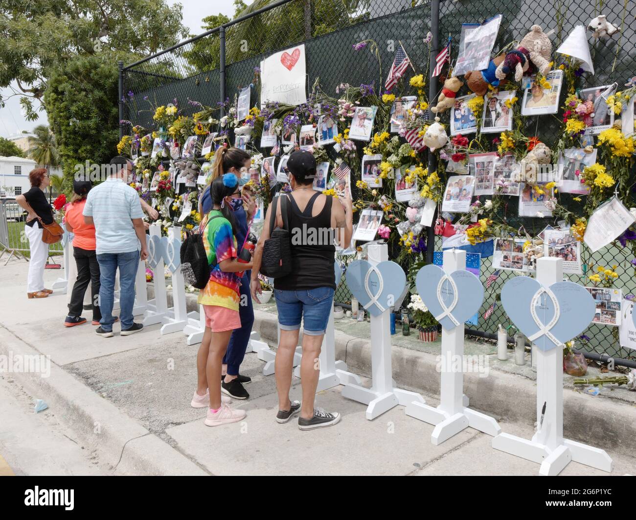 Surfside, United States. 07th July, 2021. People stop to say a prayer for the missing victims at the memorial outside St. Joseph Catholic Church near the collapsed Champlain Towers South condo in Surfside, Florida on Wednesday, July 7, 2021. News reports said that 46 people have died since the collapse over week ago. Photo By Gary I Rothstein/UPI Credit: UPI/Alamy Live News Stock Photo