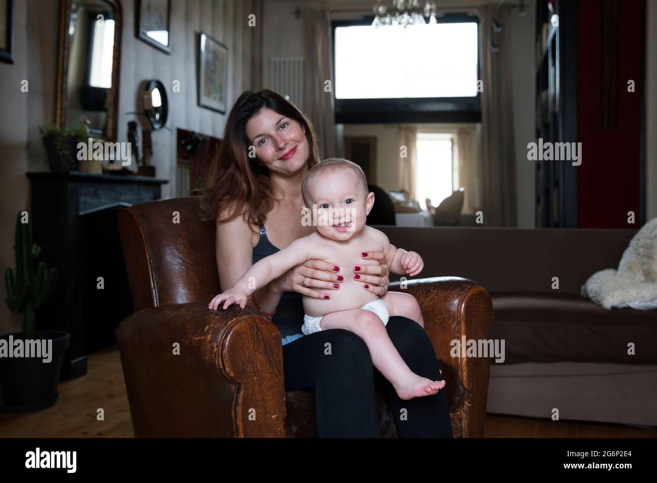 A woman with her baby on her lap Stock Photo