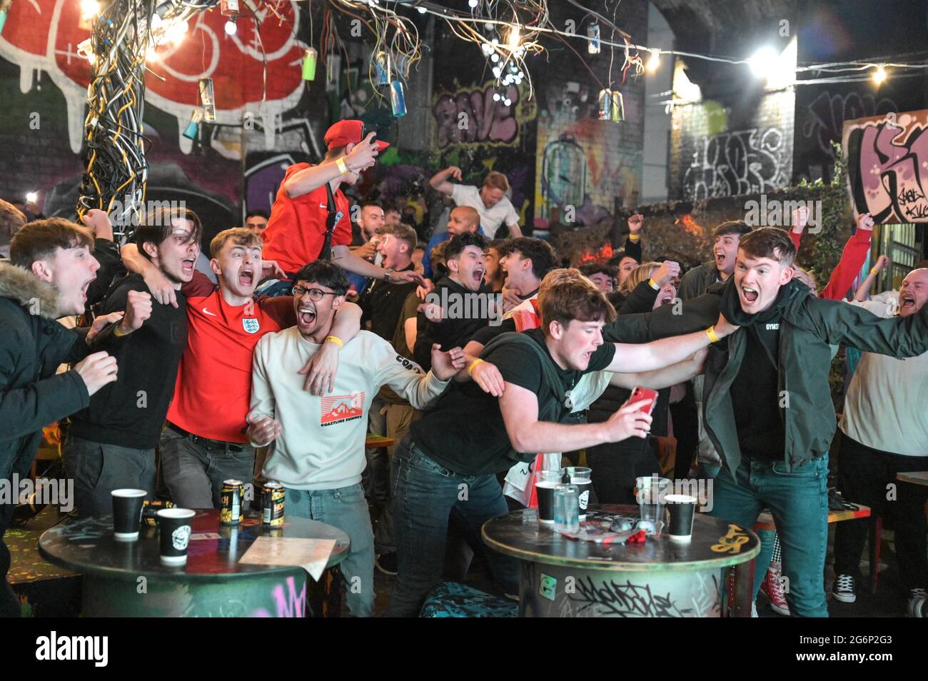 Digbeth, Birmingham, UK July 7th 2021 Fans celebrate a goal against Denmark in the Euro 2020 Semi Finals extra time. The fans erupted as they watched at The Big Fang popup bar under railway arches in Birmingham city centre. Pic by Credit: Sam Holiday/Alamy Live News Stock Photo