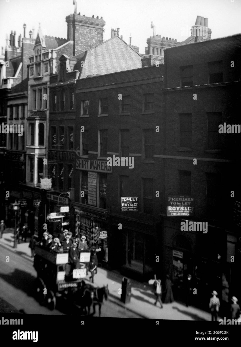 AJAXNETPHOTO. 1908-1911. LONDON, ENGLAND. - EDWARDIAN HOLBORN - VIEW OF TRAFFIC AND SHOPS ON HOLBORN AT NR 302. HORSE DRAWN OMNIBUS PASSENGERS ON OPEN TOP DECK. PHOTOGRAPHER:UNKNOWN © DIGITAL IMAGE COPYRIGHT AJAX VINTAGE PICTURE LIBRARY SOURCE: AJAX VINTAGE PICTURE LIBRARY COLLECTION REF:212904 2 Stock Photo