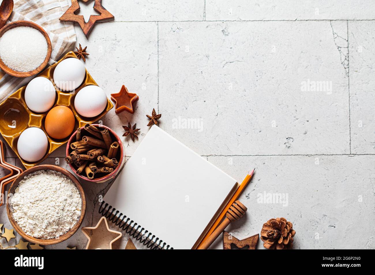 https://c8.alamy.com/comp/2G6P2N0/christmas-baking-concept-ingredients-for-christmas-cookies-on-gray-tiles-background-copy-space-flour-eggs-sugar-cinnamon-and-recipe-notebook-to-2G6P2N0.jpg