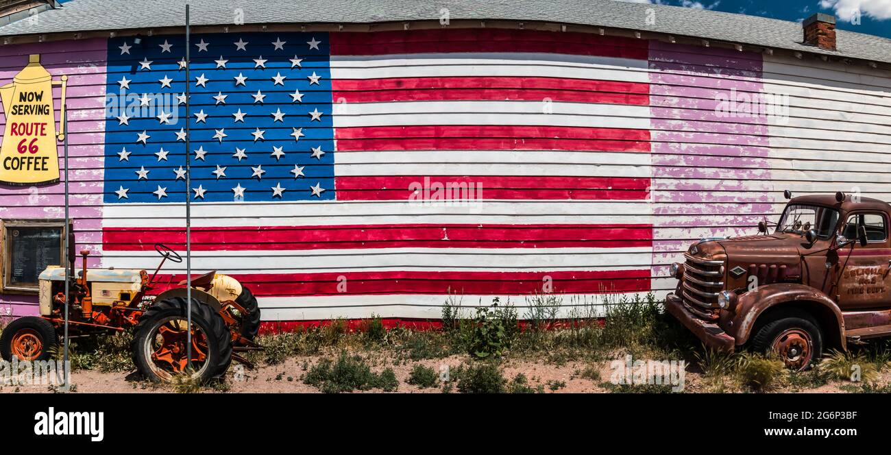 American Flag Painted on a Barn With a Tractor and Firetruck, Seligman, Arizona, USA Stock Photo