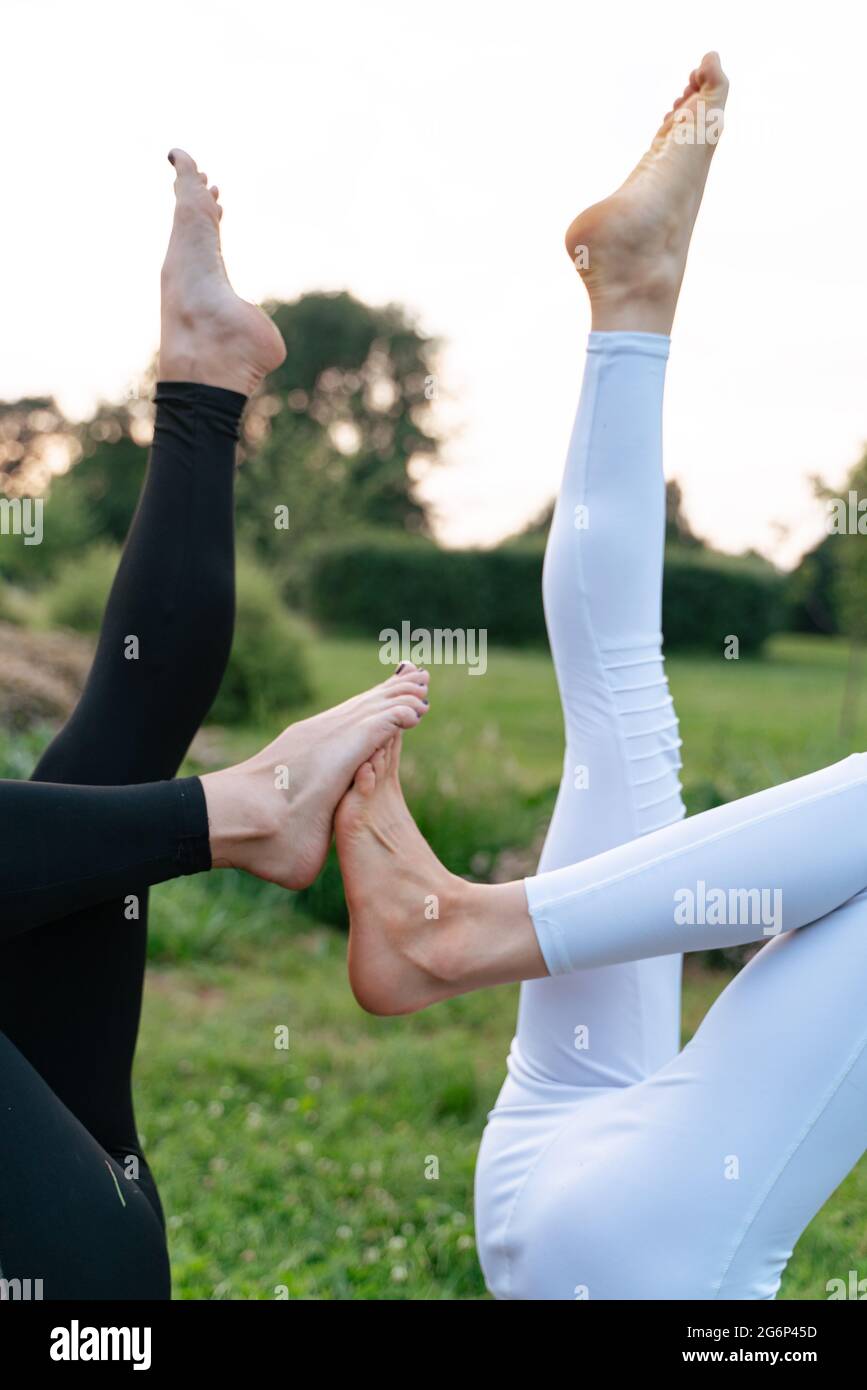 Slim young woman doing yoga in the city park Stock Photo