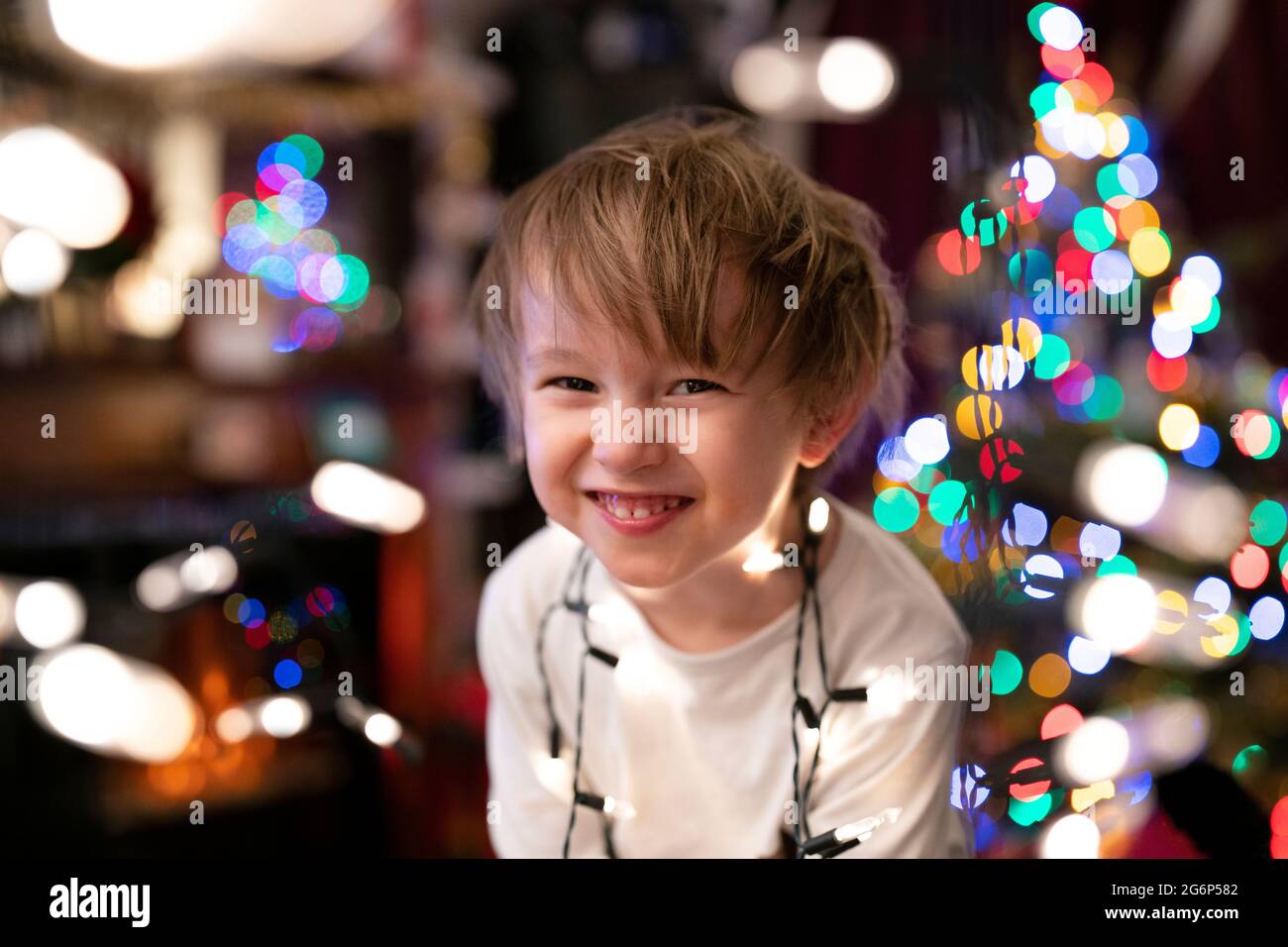 A young child playing with Christmas lights Stock Photo Alamy