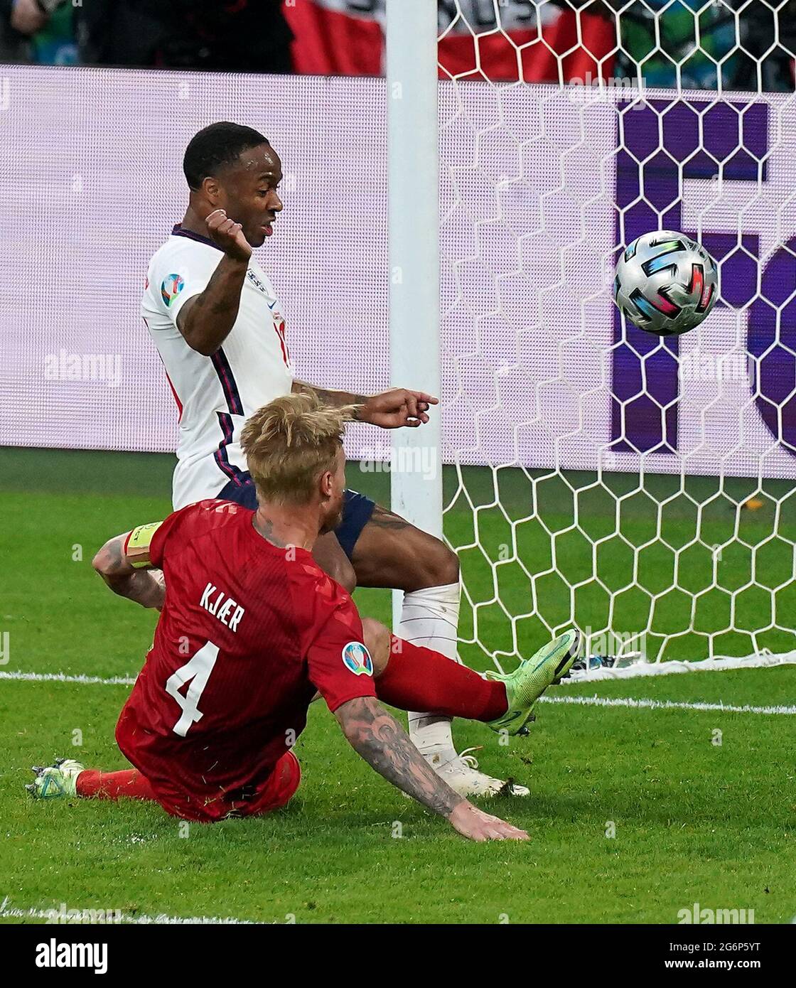 Denmark's Simon Kjaer scores an own goal under pressure from England’s ...