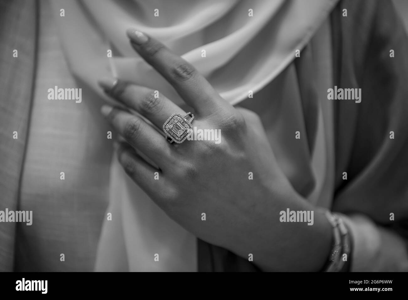 Girl hand trying diamond jewelry at jewelry shop. wearing diamond jewelry Stock Photo