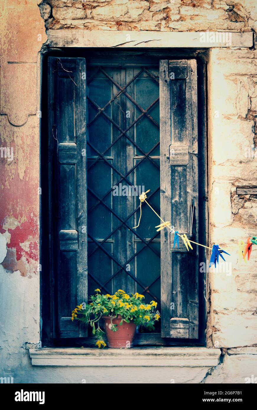 Old window with wooden shutters and clothesline Stock Photo