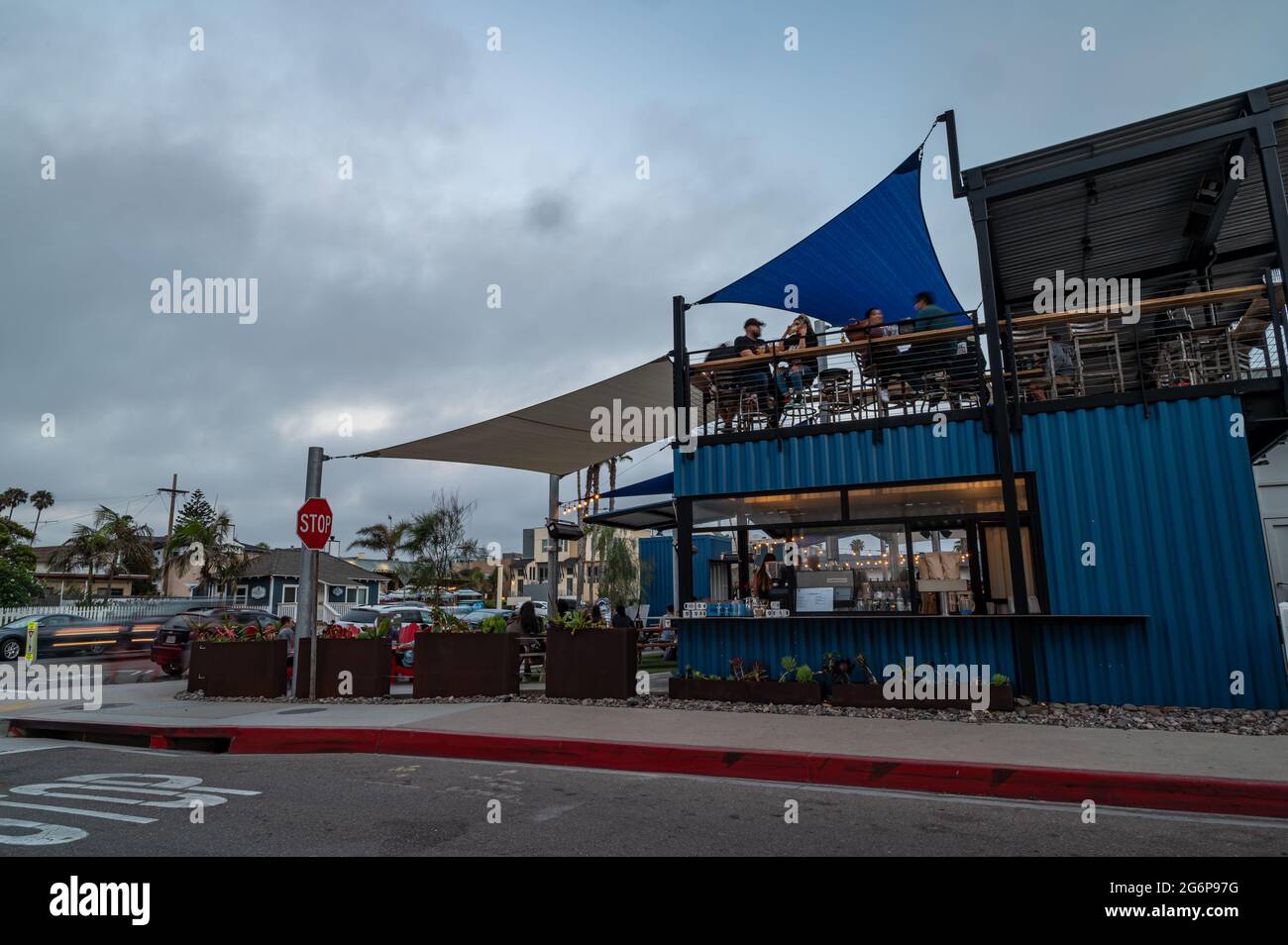 People hang out at busy outdoor restaurant Stock Photo