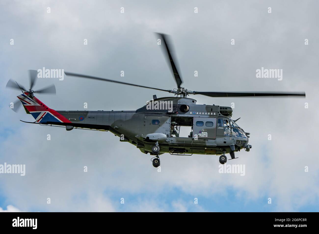 RAF Puma helicopter taking off from AAC Middle Wallop as part of the 50th Anniversary flying tour of the UK. Aircraft has union jack tail markings.. Stock Photo
