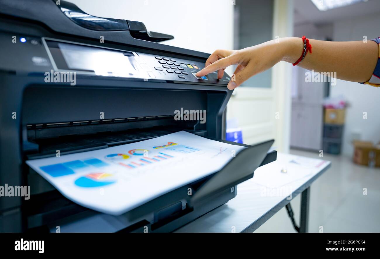 Office worker prints paper on multifunction laser printer. Copy, print, scan,  and fax machine in office. Document and paper work. Print technology Stock  Photo - Alamy