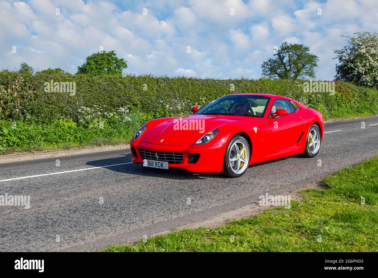 2009 red Ferrari 5999cc petrol roadster en-route to Capesthorne Hall classic May car show, Cheshire, UK Stock Photo