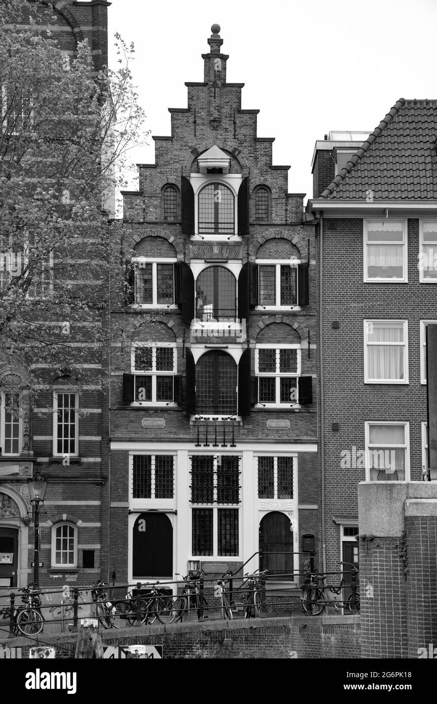 AMSTERDAM, NETHERLANDS. JUNE 06, 2021. Beautiful facades of the old dutch buildings. Black and white photography. Stock Photo