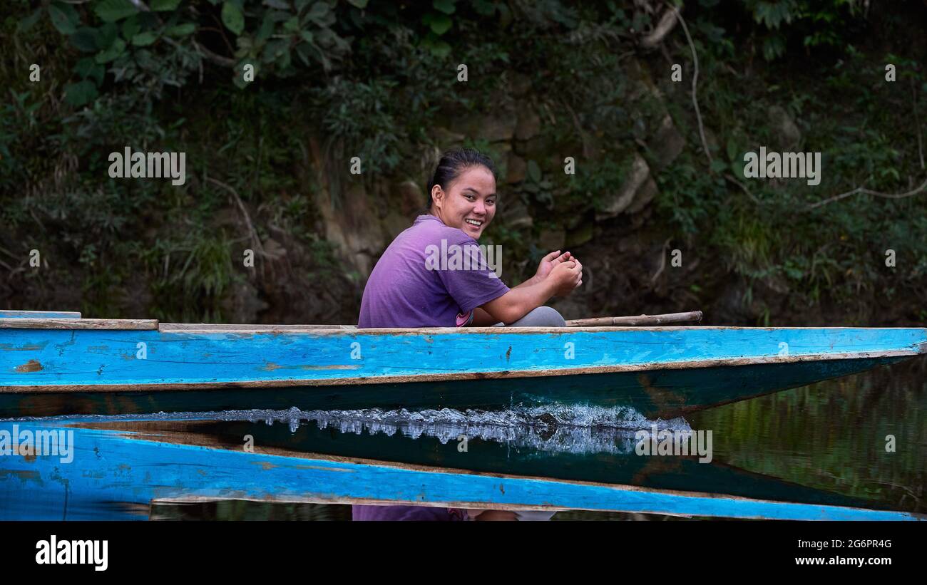 Penan girl on a boat ride along Sela'an River in Ulu Baram, Sarawak Stock Photo