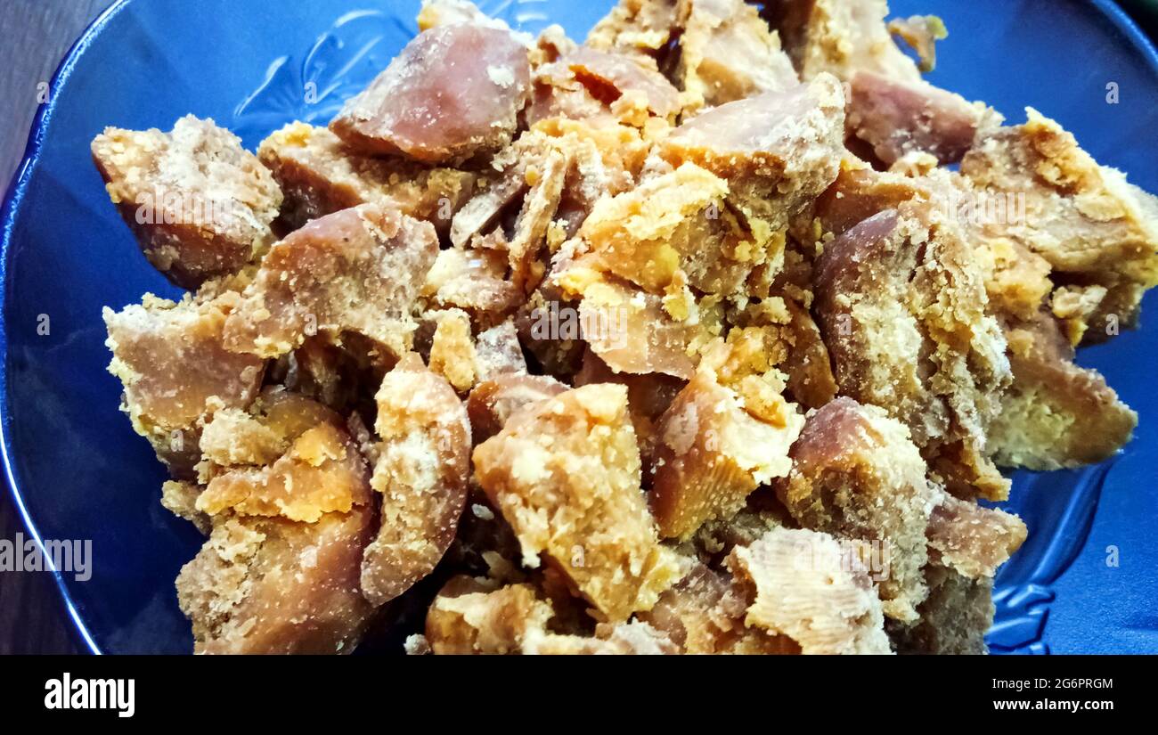 A close up shot of a bowl of Jaggery. It is a concentrated product of cane juice often date or palm sap without separation of molasses crystals can va Stock Photo