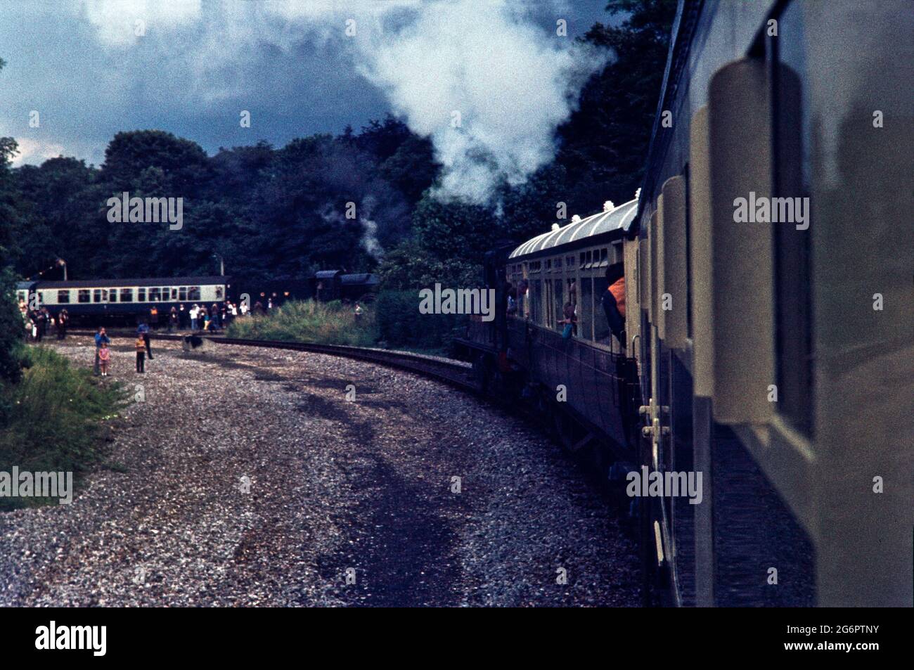 Train Spotting in the UK with a few buses circa 1975. Trains on the tracks and in the station, these are vintate trains/steam trains Stock Photo