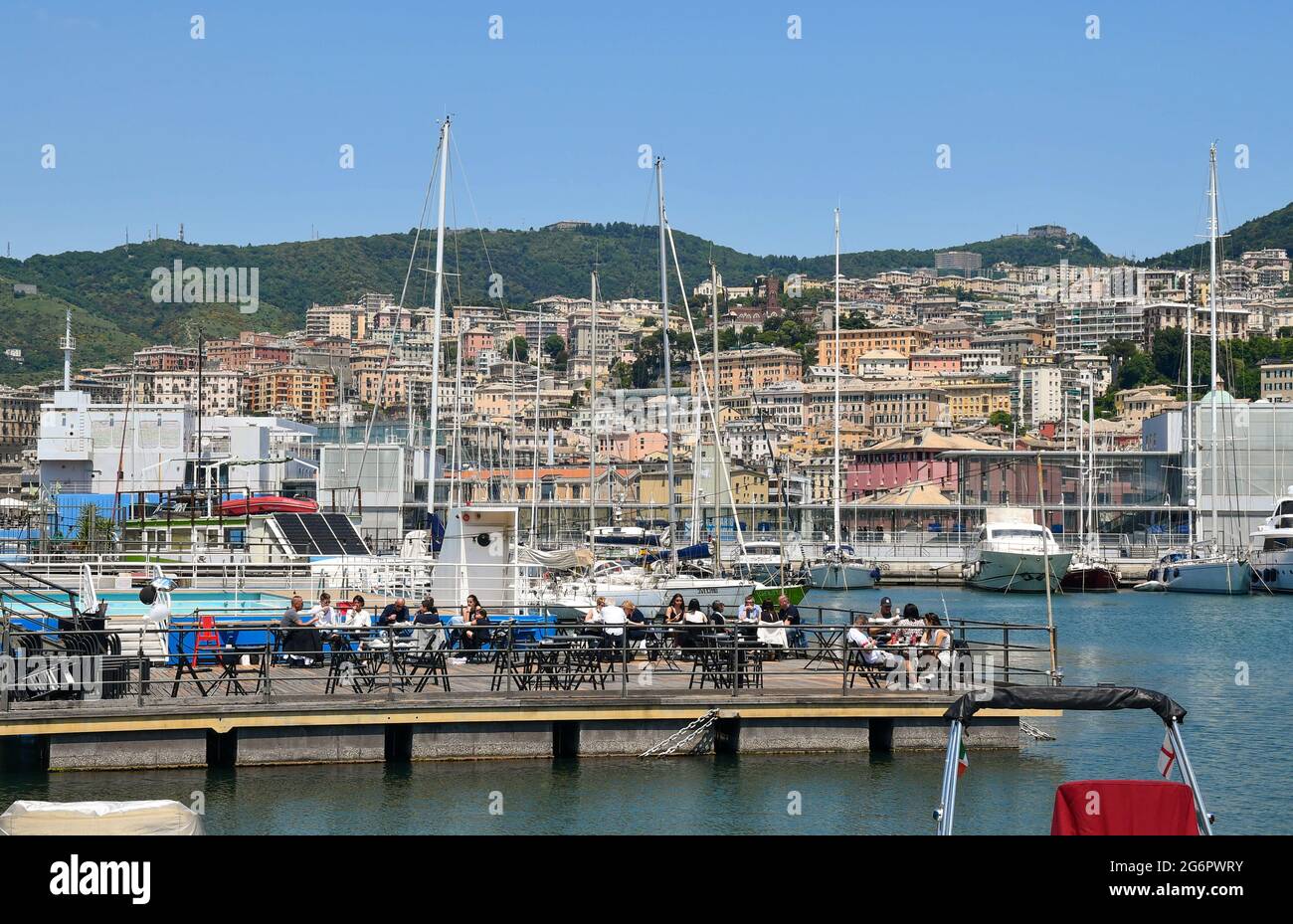 People having lunch in an outdoor restaurant by the sea at the Old Port