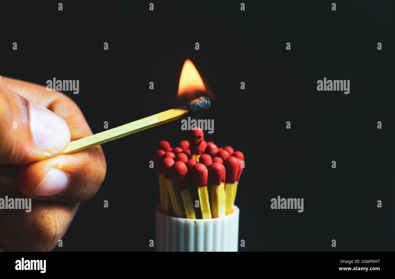 Burnout syndrome, stress, exhaustion, and work-life balance concept. Close-up of a single burnt match in a group of matches. One man standing. Stock Photo