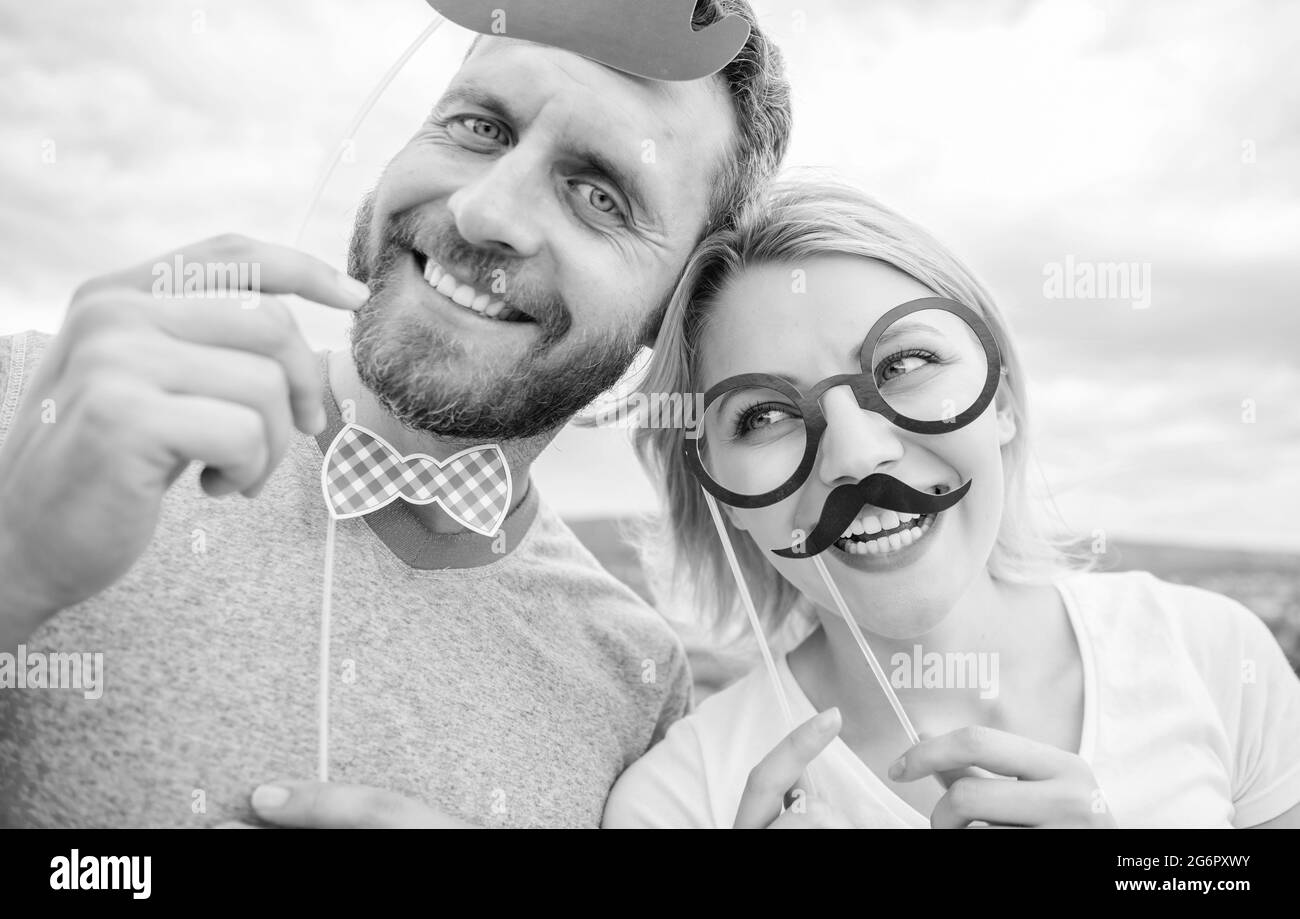 Couple posing with party props sky background. Photo booth props. Man
