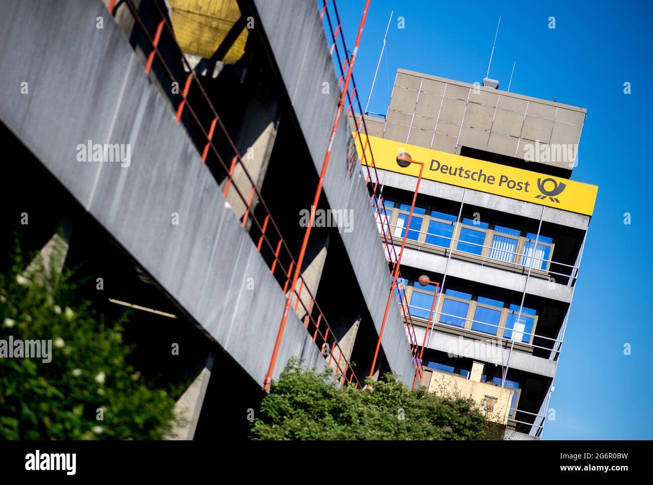 Oldenburg, Germany. 03rd July, 2021. The Deutsche Post AG logo hangs on the building of the main post office at the main station in the city centre. Credit: Hauke-Christian Dittrich/dpa/Alamy Live News Stock Photo