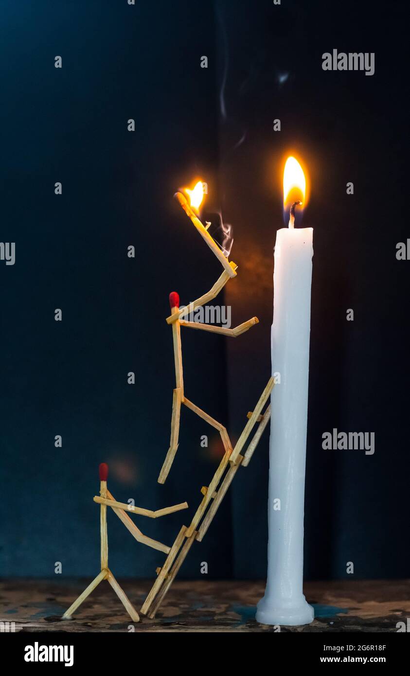 Matchsticks in form of a man lighting a candle, matchstick man lighting