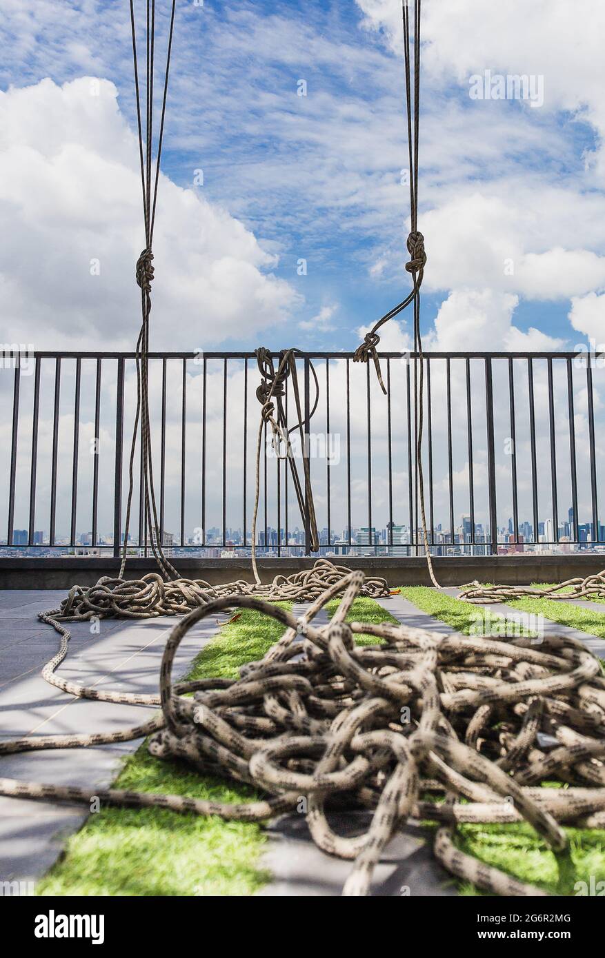 White rope tied on iron bar on building roof Stock Photo Alamy