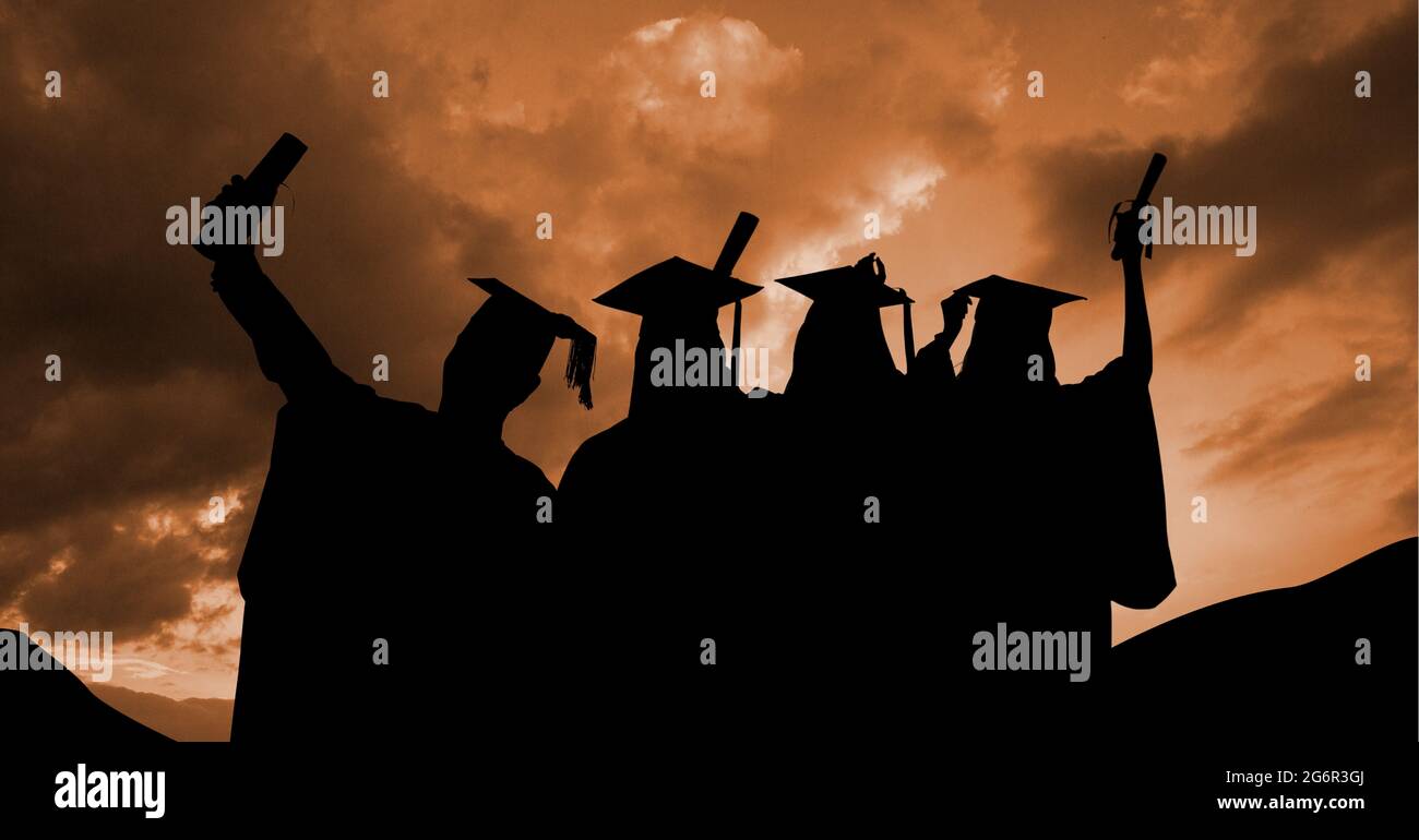 Composition of silhouettes of graduated students in caps and gowns against sunset sky Stock Photo