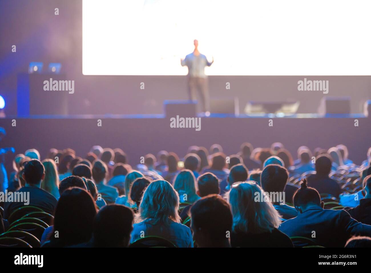 Audience sitting near illuminated stage Stock Photo Alamy