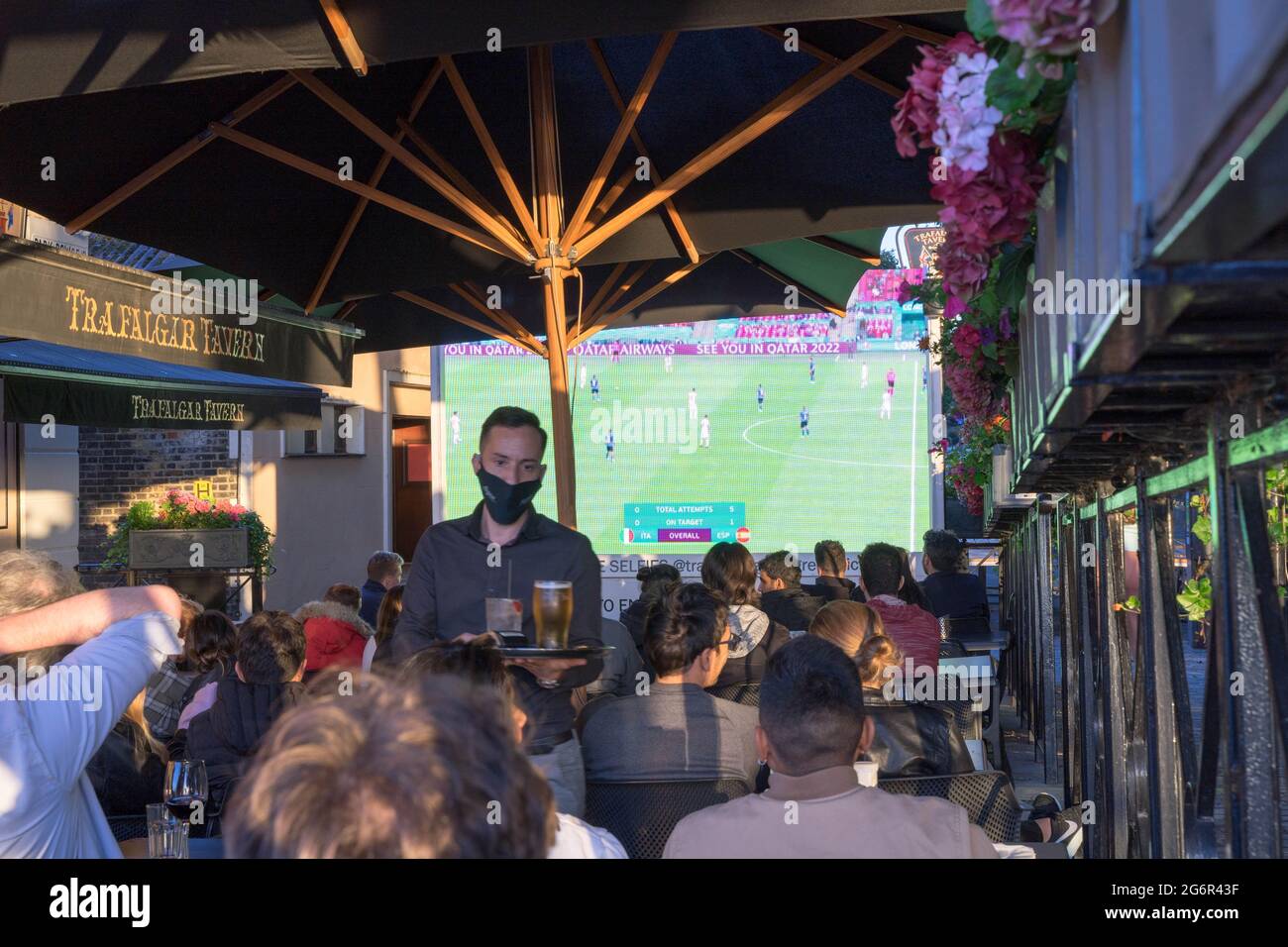 people watching euro 2020 football match at outdoor pub seating, London Greenwich tavern, Stock Photo