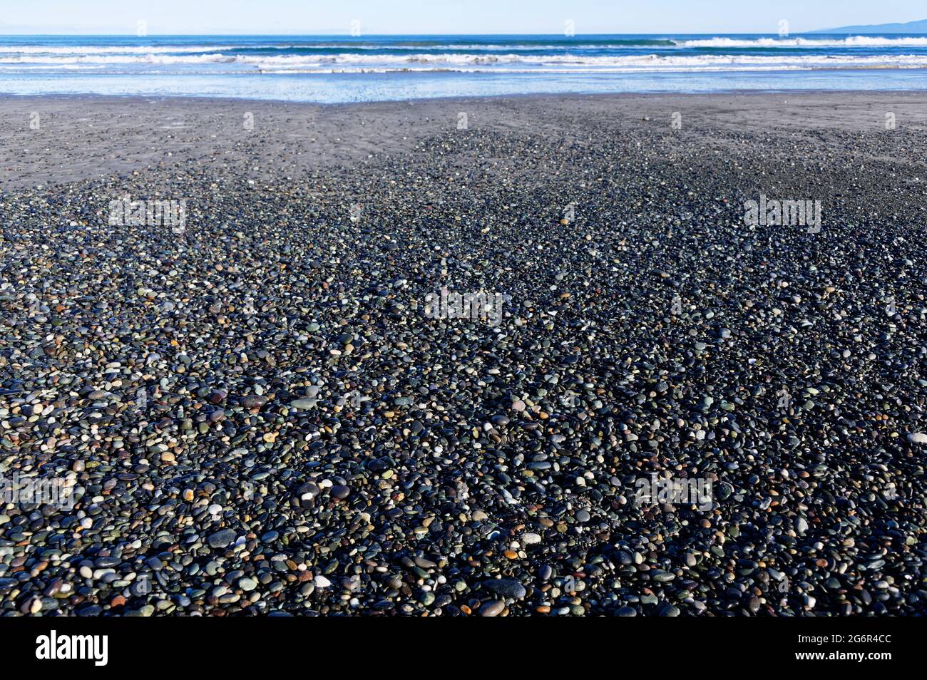 Stones and possibly gems, cover the shore at Gem Stone Beach, Western Southland, New Zealand Stock Photo