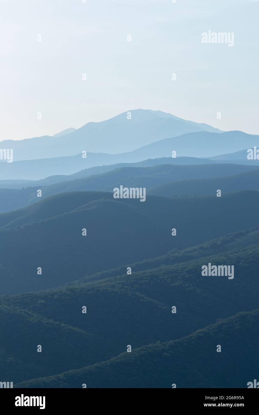 View of the mountain hills in the morning haze of fog. From bottom to top Stock Photo