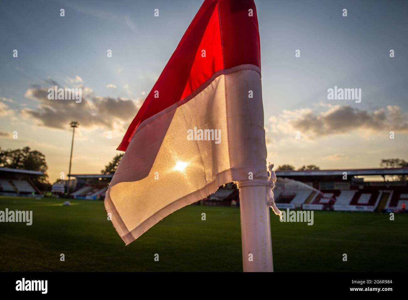 Close up of corner flag fluttering backlit by sun at football ground in UK Stock Photo