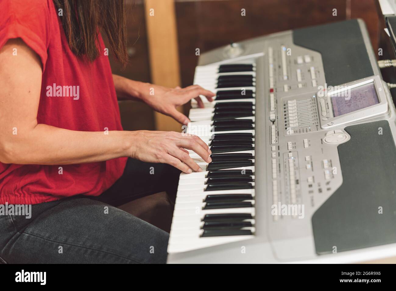 Woman playing the electronic piano Stock Photo Alamy