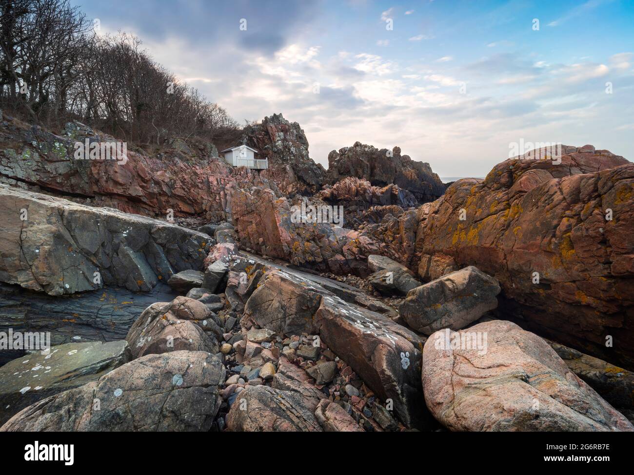Dramatic cliff landscape with small cttage on the edge. Arild, Sweden. Stock Photo