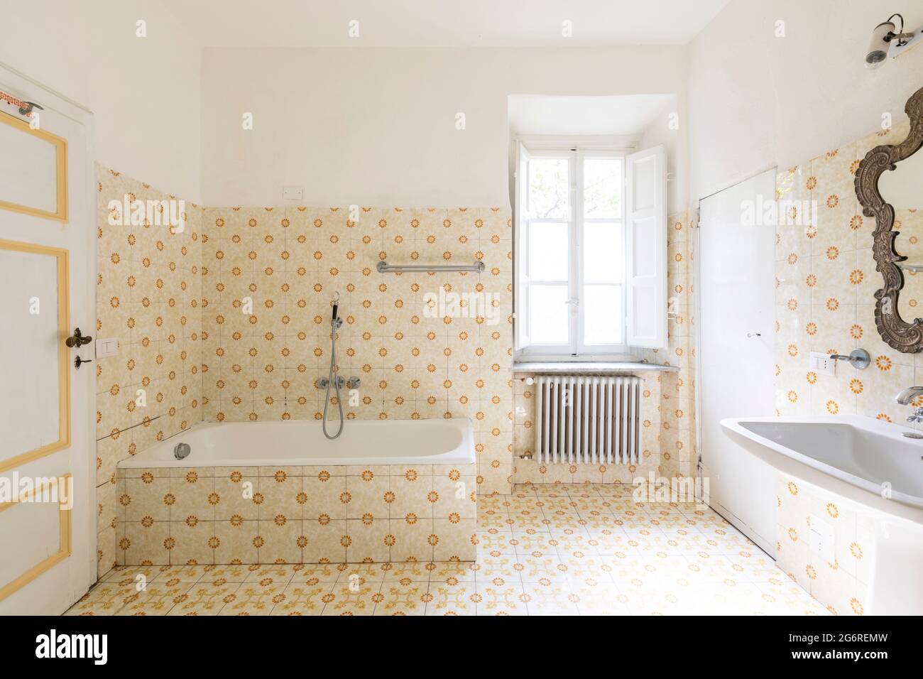 Interior of an old bathroom with window and bathtub. Stock Photo