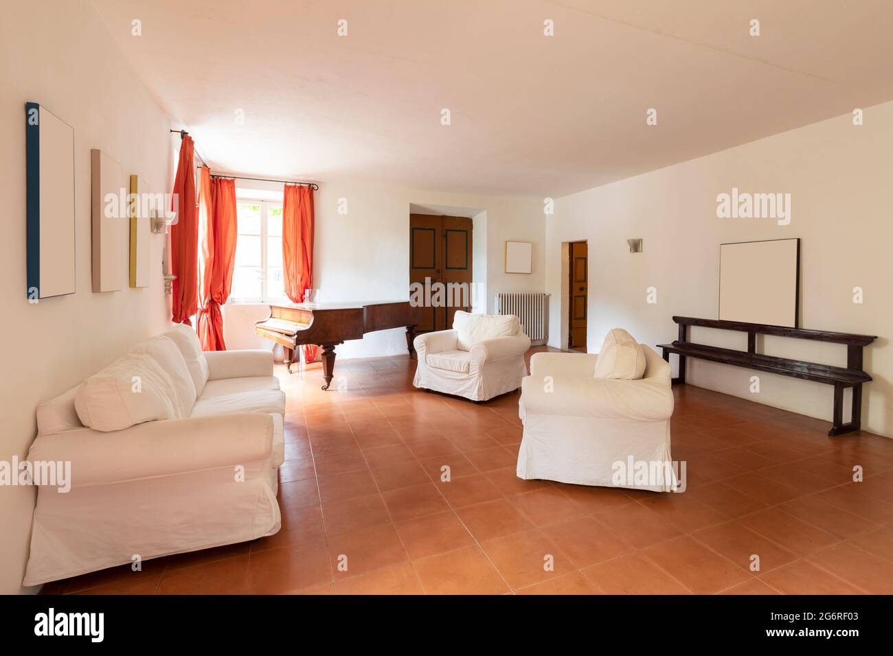 Large living room with white armchairs and sofas. A bit decadent environment. No people inside. Stock Photo