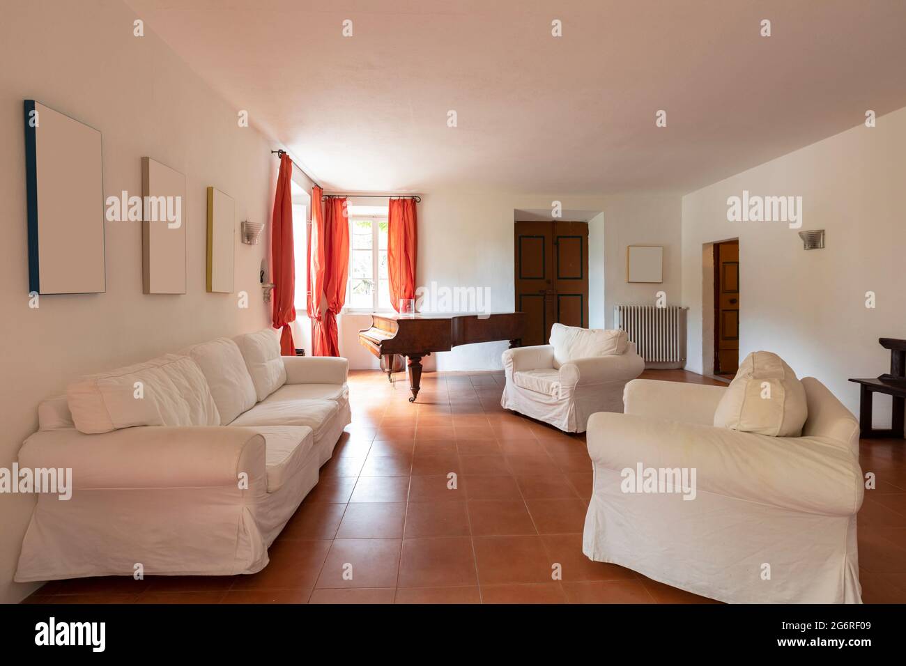 Large living room with white armchairs and sofas. A bit decadent environment. No people inside. Stock Photo