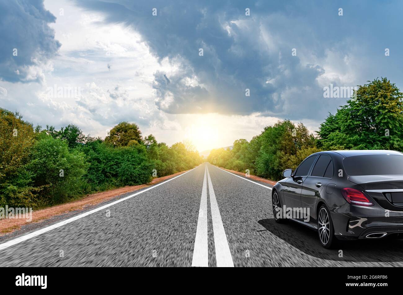 The car moves on a mountain road on a summer sunny day. Stock Photo