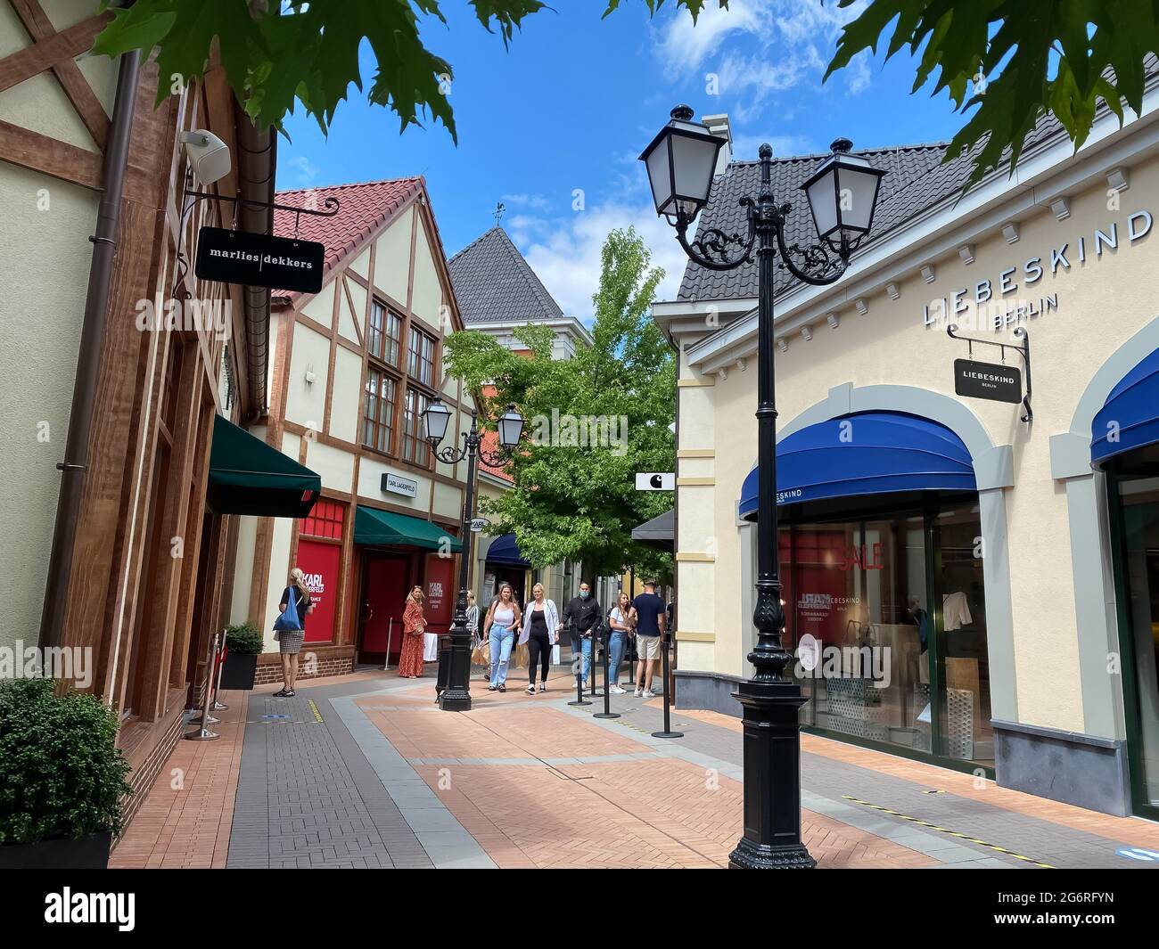 Roermond (designer outlet), Netherlands - July 1. 2021: View on exterior  shopping street with stores and people walking Stock Photo - Alamy